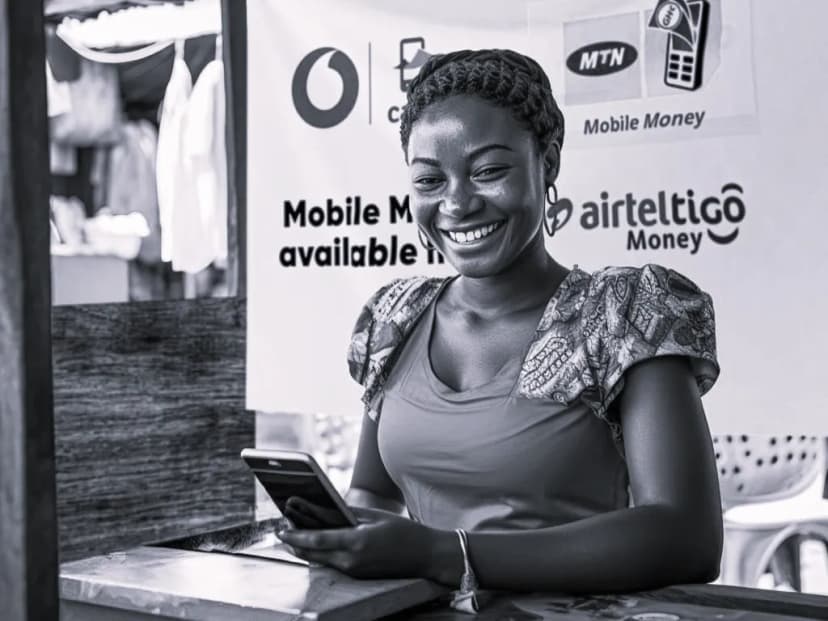 Person smilling near mobile money stand